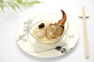 Delicate steamed rice vermicelli with crab claw and smooth egg white in a fine dining presentation