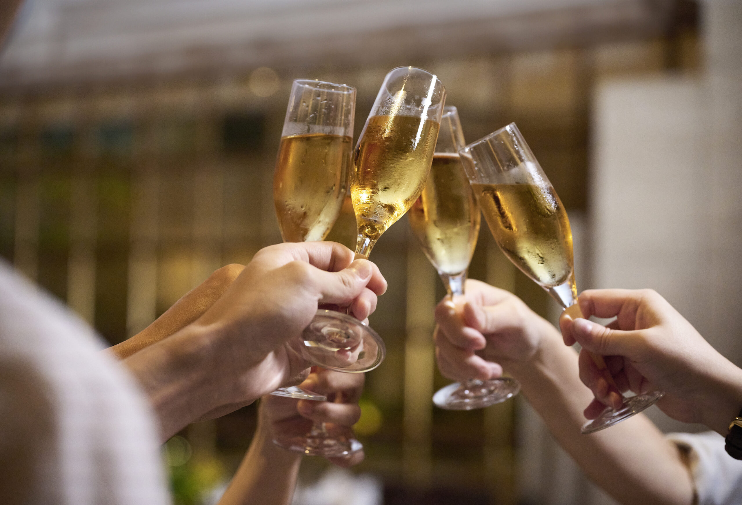 Champagne glasses toasting at a celebration dinner in Li Bai Cantonese Restaurant Singapore