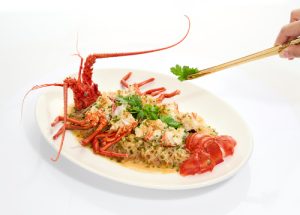 Steamed Australian lobster with rice vermicelli and garlic, served on a white oval plate - Li Bai Restaurant, Cantonese fine dining, Sheraton Towers Singapore